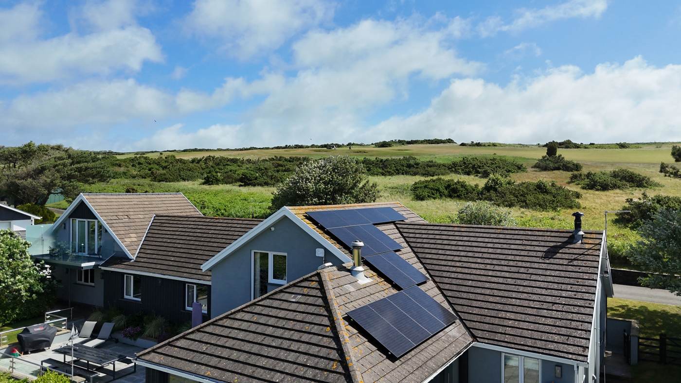 Solar panels split across three roof pitches of a coastal home