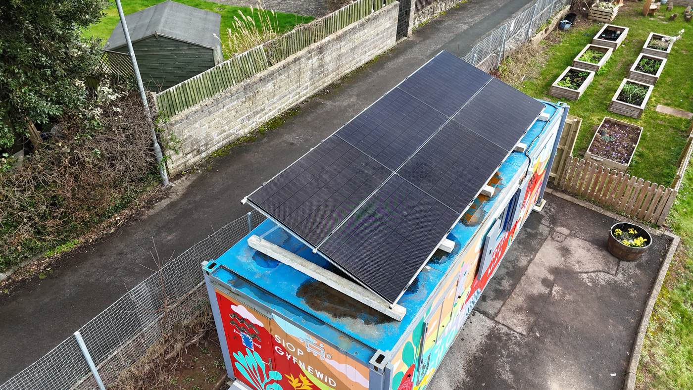 Tilt-frame solar on a community swap shop container